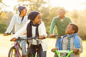 46685271 - young smiling family doing a bike ride on an autumns day